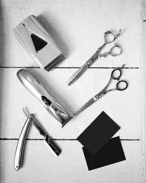Barber scissors, typewriter and razor on white background Stock Photos