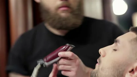 Barber shave and modeling beard at the hair salon Stock Footage 252660541