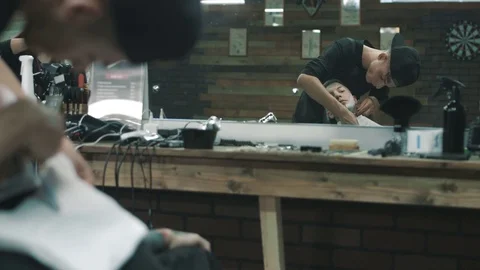 Barber shaves the beard of the client. Stock Footage 80025099