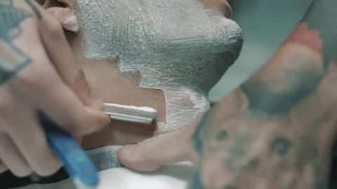 Barber shaves the beard of the client. Stock Footage 80028789