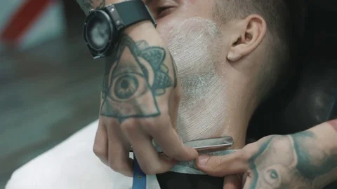 Barber shaves the beard of the client. Stock-Footage 80029594