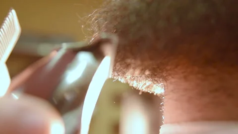 Barber shaves the client's beard with an electric razor Stock-Footage 100643553