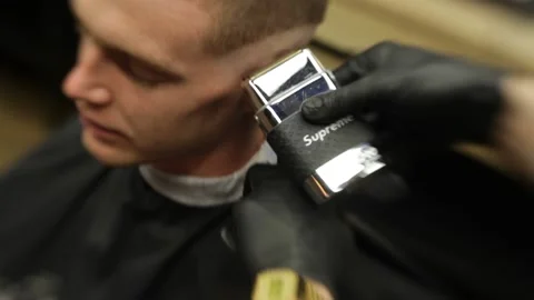 Barber Shaves  Man's Head Using Electric Razor Stock Footage 139765366