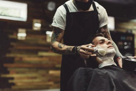 Barber shaving client Stock Photos