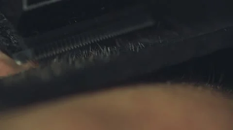 Barber shaving a client's beard with electrical shaving machine, close up Stock Footage 67315759