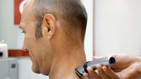 Barber is shaving his client in old fashion manner Stock Photos