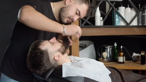 Barber shaving neck of client with razor Stock Footage 127174849