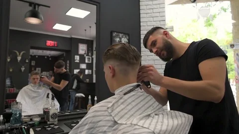 Barber shears the client's hair. side view Stock Footage