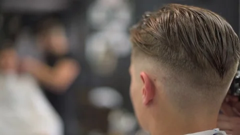 Barber shears the client's hair. side view Stock Footage