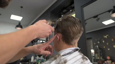 Barber shears the client's hair. side view Stock Footage