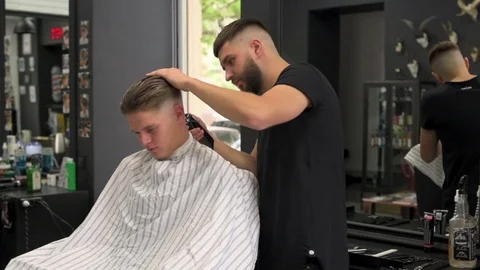 Barber shears the client's hair. side view Stock Footage