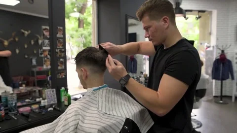 Barber shears the client's hair. side view Stock Footage 80582341