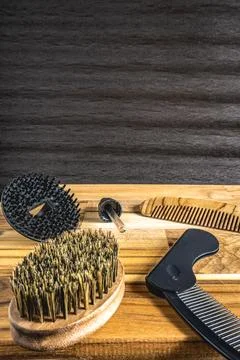 Barber shop flatlay, with different combs and brushes on a wooden table Stock Photos