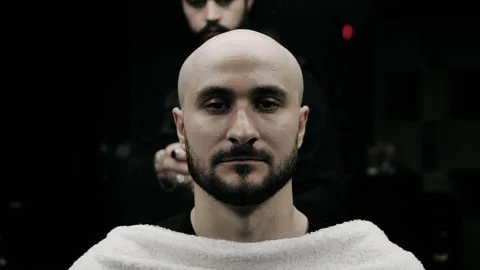 Barber spraying aftershave on beard of a customer. Stock Footage 150271979