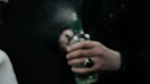Barber spraying aftershave on beard of a customer. Stock Footage 150272048