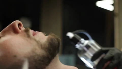 Barber Sprays Perfume On A Client New Haircut and beard Stock Footage 139765278