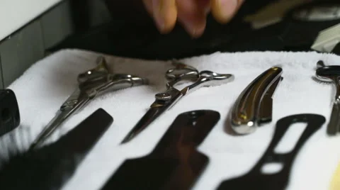 Barber takes scissors from a full tool board slow motion Stock Footage 60051117