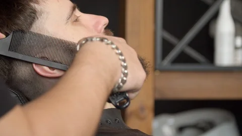 Barber trimming beard of client Stock Footage 127174028