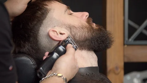 Barber trimming beard of client Stock Footage 127174456