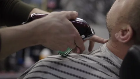Barber trimming beard to his client Stock Footage 88144871
