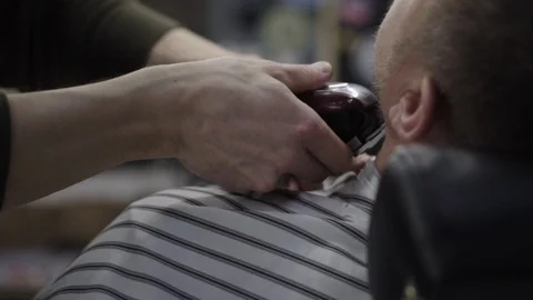 Barber trimming beard to his client Stock Footage 88144994
