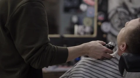 Barber trimming beard to his client Stock Footage 88157753