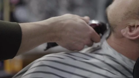 Barber trimming beard to his client Stock Footage 88158790