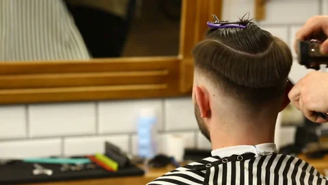 Barber trimms hair of client with scissors and brush Stock Footage 91214474