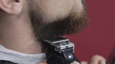 Barber trims beard with clippers Video stock 147452777
