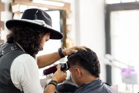 Barber using hair clipper on client. Hipster stylist. Hair Stimulation growth Stock Photos