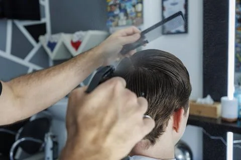 Barber Using Spray Bottle While Styling Client Hair in Contemporary Barbersho Stock Photos