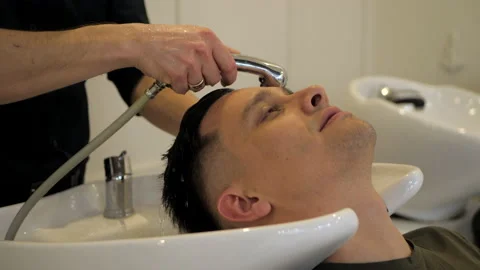 Barber washes client hair Stock Footage 151927241