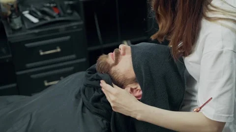 Barber Wiping Client's Beard After Haircut Stock Footage 345586080