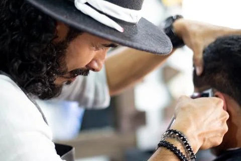 Barber at work. Close-up. Cutting and fixing hair. Stock Photos