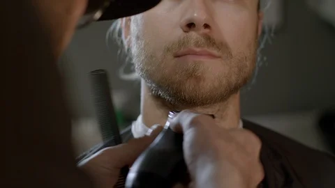 Barber At Work Trimming Young Handsome Man's Beard At The Barbershop Stock Footage 97866056