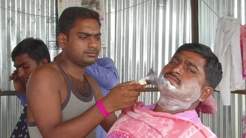 Barber working in his small shop Stock Footage 77572127
