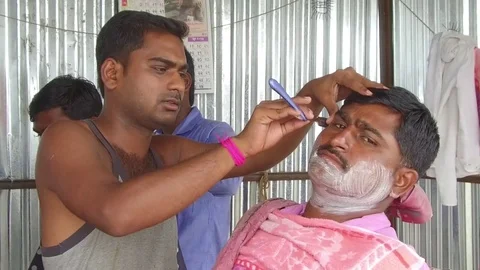 Barber working in his small shop Stock Footage 77572188