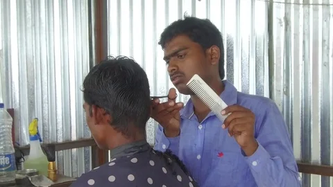 Barber working in his small shop Stock Footage 77572226