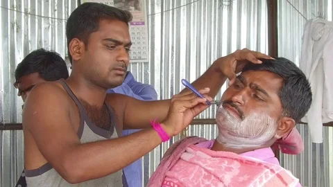 Barber working in his small shop Stock Footage 77572235