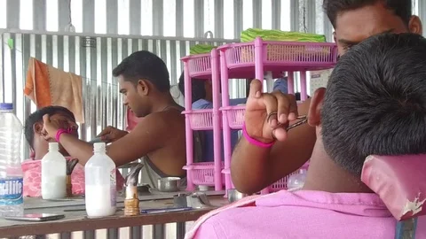 Barber working in his small shop Stock Footage