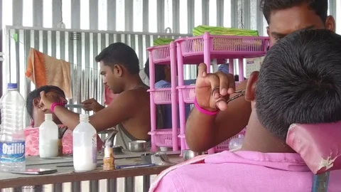 Barber working in his small shop Stock Footage 77572344