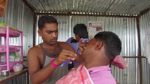 Barber working in his small shop Stock Footage 77650383
