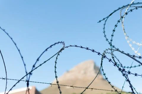 Barbwire wall for security at prison Stock Photos