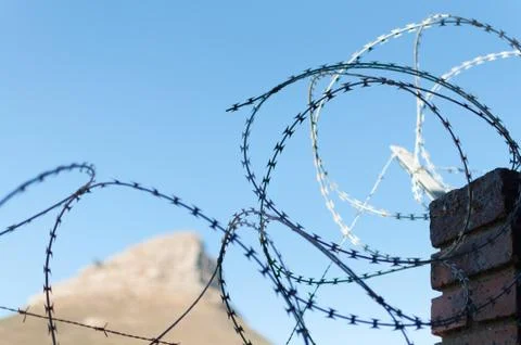 Barbwire wall for security at prison Stock Photos