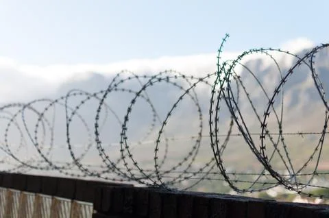 Barbwire wall for security at prison Stock Photos