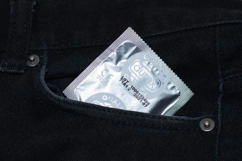 BARCE, SPAIN - Sep 01, 2020: Condom in jeans pocket. Texture, background. Stock Photos