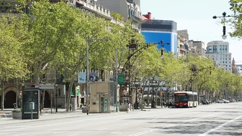 Barcelona - March 29, 2020. Empty Passeig de Gracia street with a lonely bus. Video stock 128374725