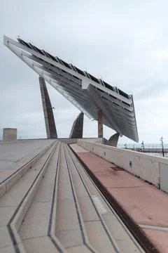 Barcelona's iconic solar panel structure on a cloudy day by the sea Stock Photos