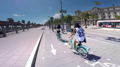 Barcelona,Spain- AUGUST 21, 2015: Young people riding bicycles on the street Stock Footage 55156760