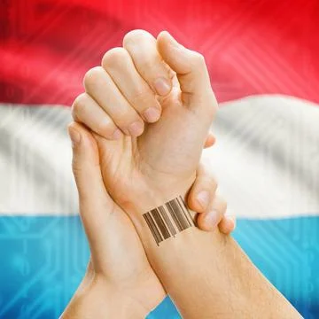 Barcode ID number on wrist and national flag on background - Luxembourg Ba... Stock Photos